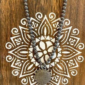 Diamond sun charm on beaded necklace. 18 inches. Magnetic clasp.